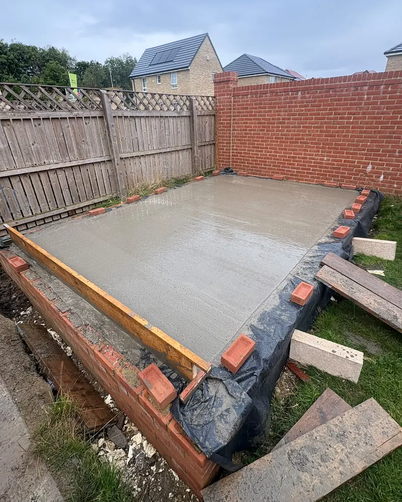 Concrete slab poured inside the brick footings, over a damp-proof membrane