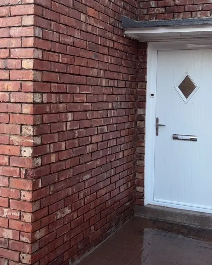 Finished red brickwork around the front door of a house