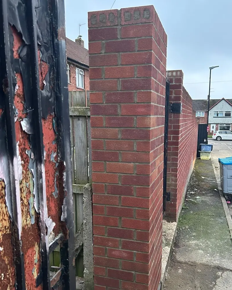 Side view of the new brick gate pillar along the back lane