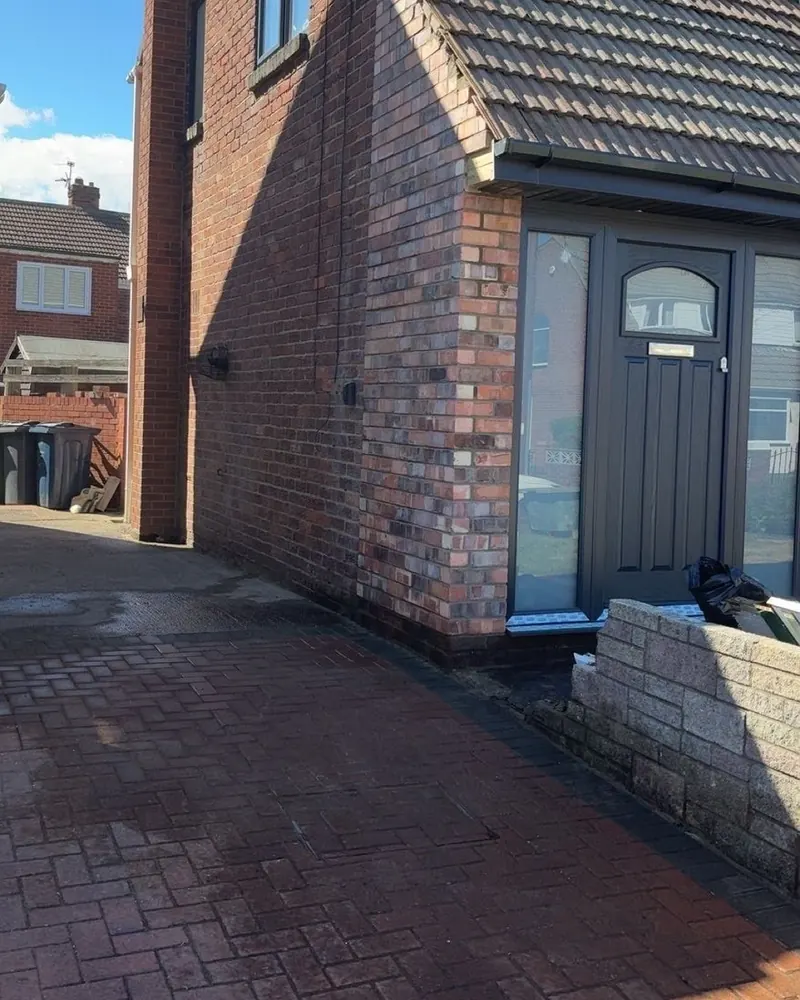 The finished front porch, its brick corner pier blending in with the house