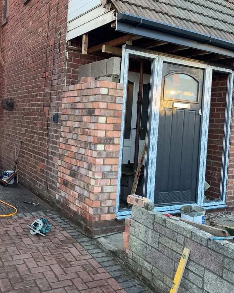 Front porch part-built, with the brick corner pier and blockwork going up around the new door frame