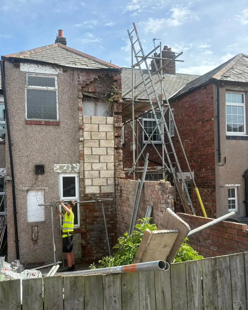 Scaffold up at the back of the terraced house, with the old opening blocked up