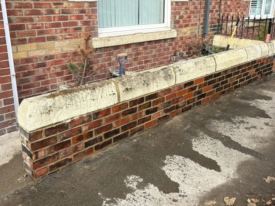 The same brick front garden wall, rebuilt